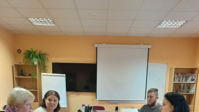 daudz cilvēku apspriedē ap galdu