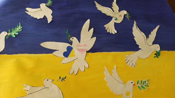 Bērnu zīmējums ar Ukrainas karogu un miera baložiem