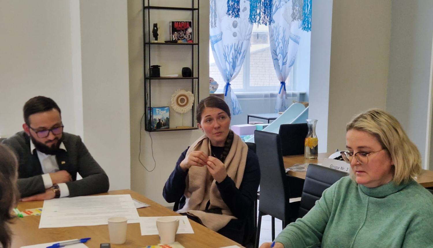 daudz cilvēku ap galda