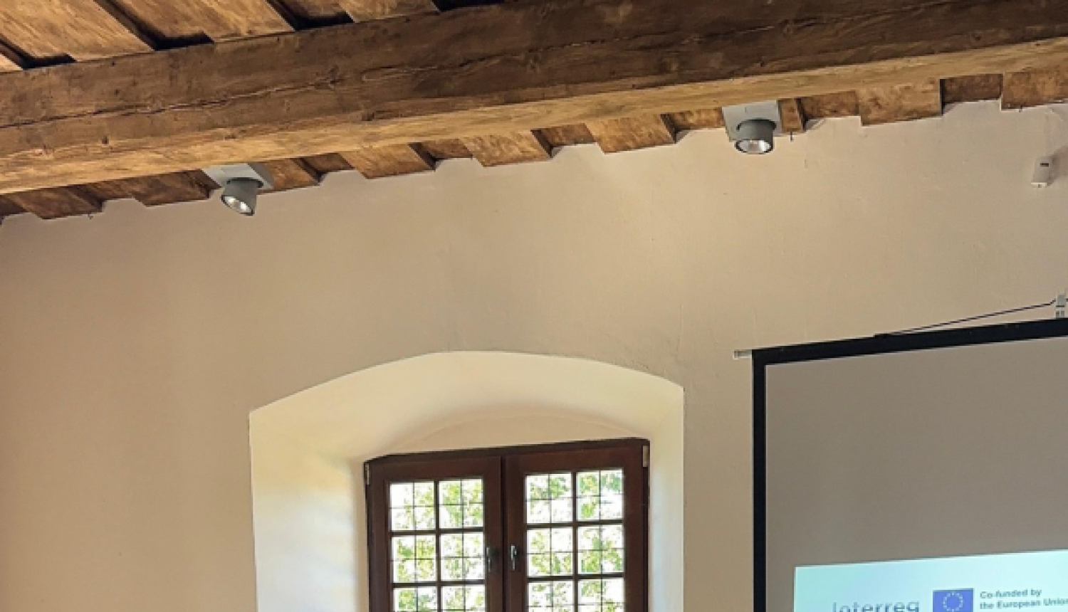 divi vīriešipie galda paraksta dokumentus